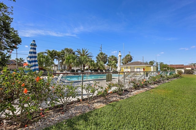 pool featuring a yard and fence