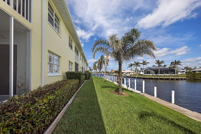 exterior space with a water view and a lawn