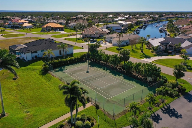 drone / aerial view featuring a water view and a residential view