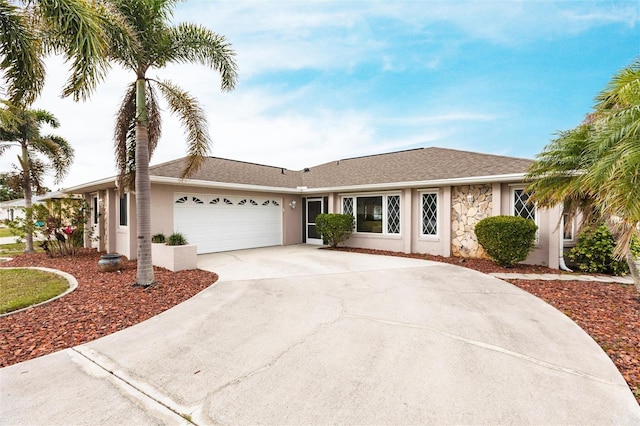 ranch-style home with driveway, stone siding, an attached garage, and stucco siding