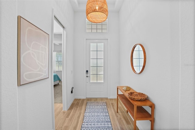 doorway featuring wood tiled floor and baseboards