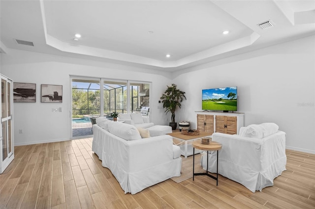 14724 Cherry Blossom Way, Punta Gorda, FL 33955 - living room featuring light wood-style floors, a tray ceiling, a sunroom, and visible vents