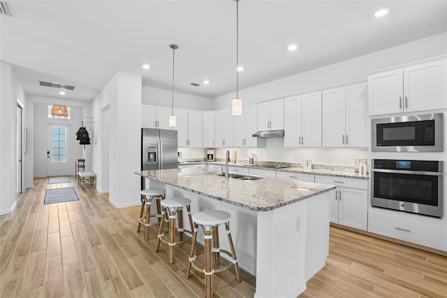 14724 Cherry Blossom Way, Punta Gorda, FL 33955 - kitchen featuring stainless steel appliances, a sink, white cabinetry, visible vents, and light wood-style floors