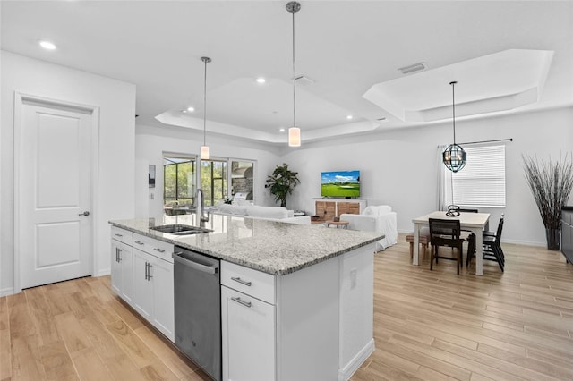 14724 Cherry Blossom Way, Punta Gorda, FL 33955 - kitchen with a tray ceiling, light wood finished floors, visible vents, a sink, and dishwasher