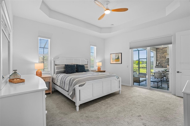 14724 Cherry Blossom Way, Punta Gorda, FL 33955 - bedroom featuring access to exterior, a raised ceiling, a ceiling fan, and light colored carpet