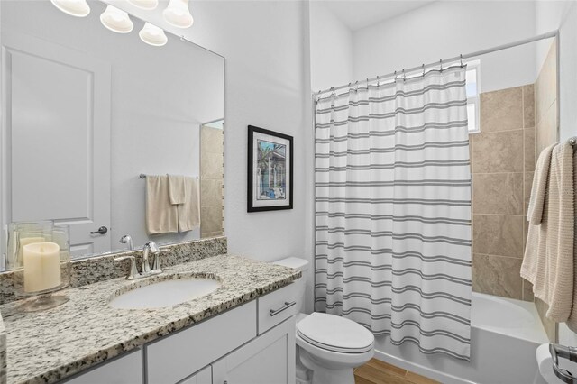 14724 Cherry Blossom Way, Punta Gorda, FL 33955 - full bath featuring wood finished floors, vanity, toilet, and shower / bath combo with shower curtain