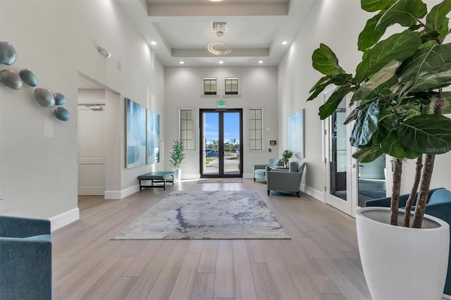14724 Cherry Blossom Way, Punta Gorda, FL 33955 - entryway with baseboards, visible vents, wood finished floors, a high ceiling, and french doors