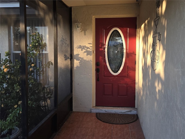 view of exterior entry featuring stucco siding