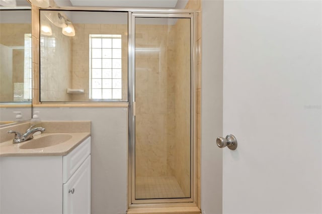 full bathroom with a shower stall and vanity