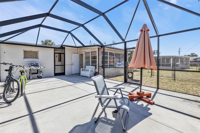 view of patio / terrace featuring glass enclosure