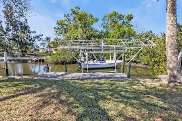 view of dock with a water view and a lawn