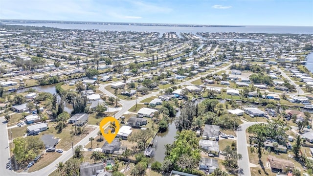 birds eye view of property with a water view and a residential view