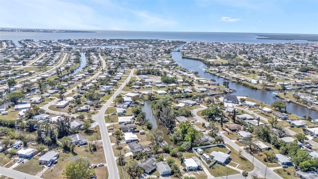 bird's eye view featuring a water view and a residential view