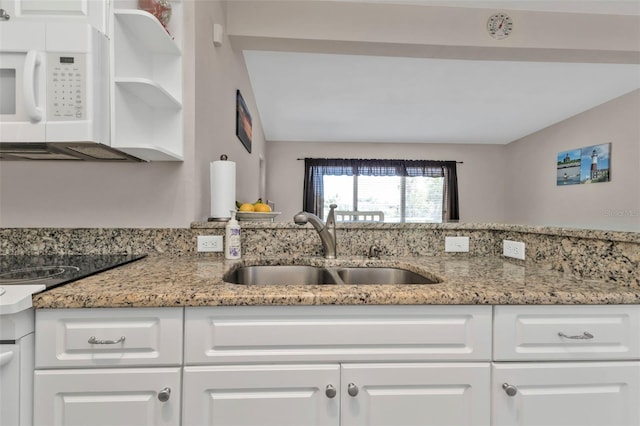 3627 Easy St, Port Charlotte, FL 33952 - kitchen featuring a sink, white microwave, white cabinetry, light stone counters, and open shelves