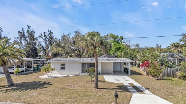 3627 Easy St, Port Charlotte, FL 33952 - view of front of home featuring driveway, a carport, a front yard, and stucco siding