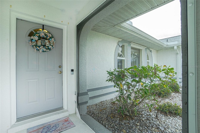 view of exterior entry featuring stucco siding