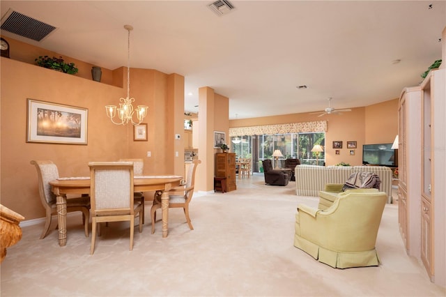 dining space with light colored carpet, visible vents, baseboards, and ceiling fan with notable chandelier