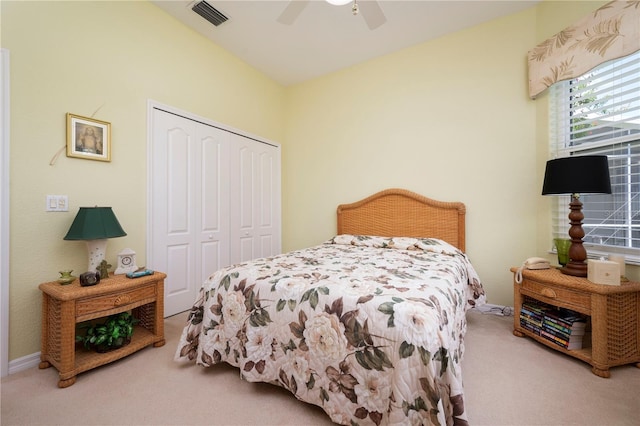 carpeted bedroom featuring a closet, visible vents, ceiling fan, and baseboards