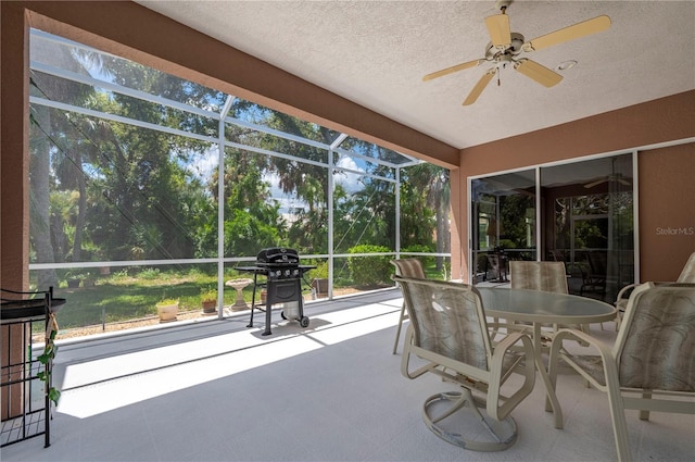 sunroom / solarium with a ceiling fan