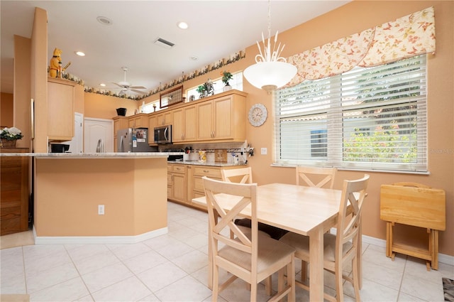 kitchen featuring pendant lighting, stainless steel appliances, visible vents, backsplash, and light brown cabinetry