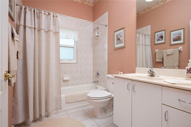 full bathroom with tile patterned flooring, shower / tub combo with curtain, vanity, and toilet