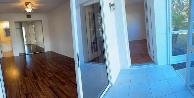 corridor with visible vents and wood finished floors