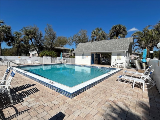 pool featuring a patio area and fence