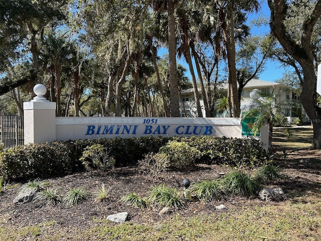 community / neighborhood sign featuring fence