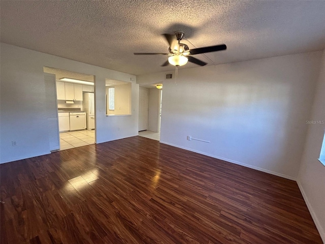 unfurnished living room with ceiling fan, a textured ceiling, wood finished floors, and visible vents