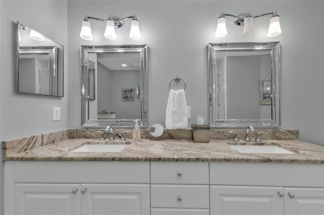 full bathroom with double vanity and a sink