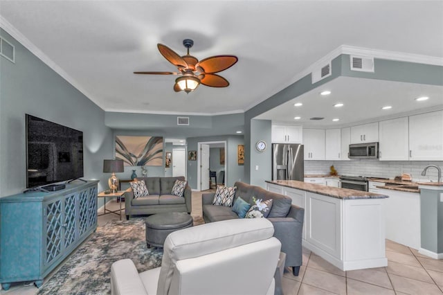 living area featuring ornamental molding, visible vents, and light tile patterned floors