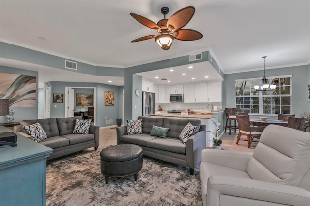 living area with recessed lighting, visible vents, crown molding, and ceiling fan with notable chandelier