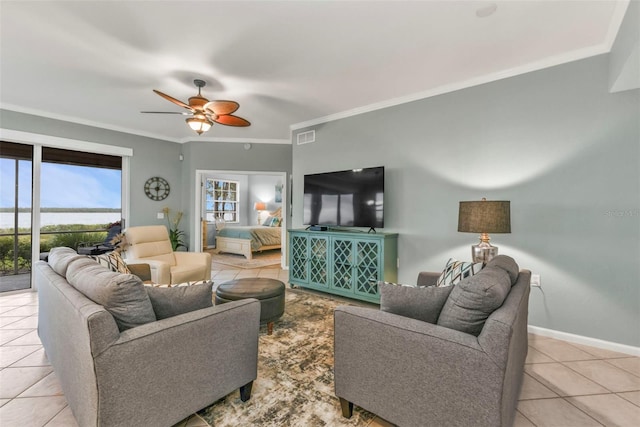 tiled living room featuring a ceiling fan, visible vents, ornamental molding, and baseboards