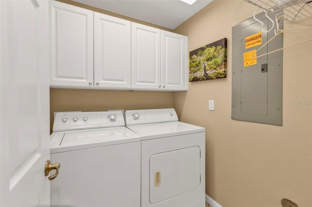 laundry room featuring cabinet space, electric panel, and independent washer and dryer