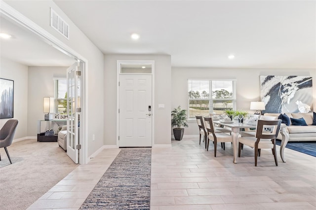 entryway with a wealth of natural light, visible vents, light wood finished floors, and recessed lighting