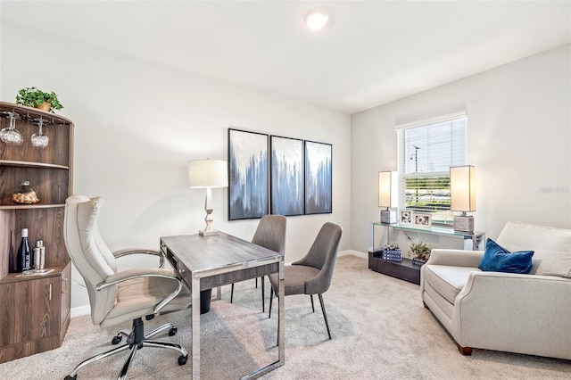 home office featuring light colored carpet and baseboards