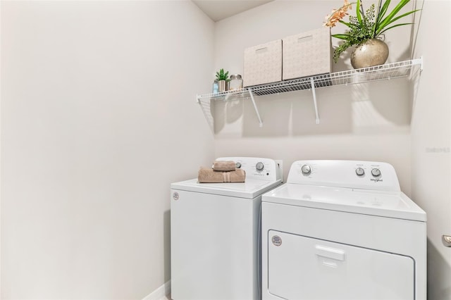 laundry room featuring washing machine and dryer, laundry area, and baseboards