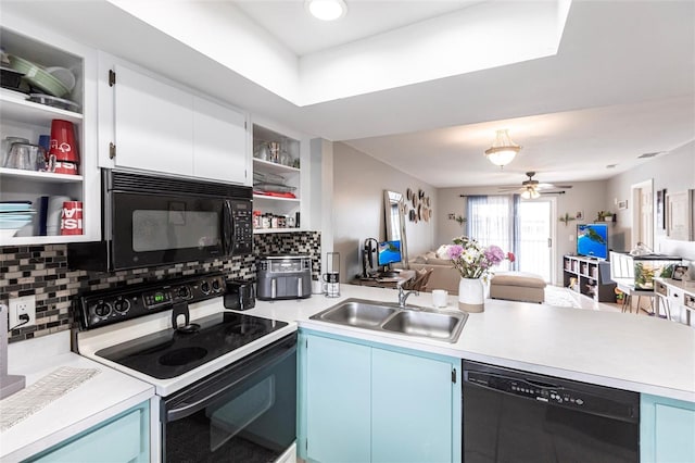 kitchen featuring blue cabinets, open shelves, a sink, light countertops, and black appliances