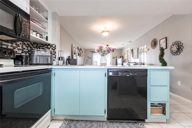 kitchen featuring open shelves, tasteful backsplash, light countertops, blue cabinets, and black appliances