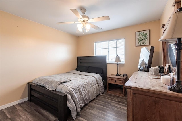 bedroom with dark wood finished floors, a ceiling fan, and baseboards