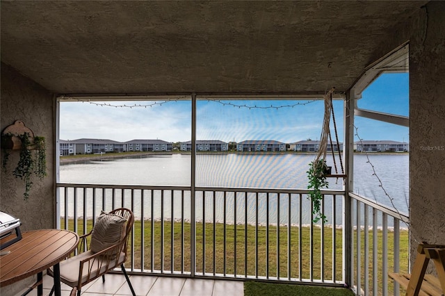 balcony with a water view and a residential view