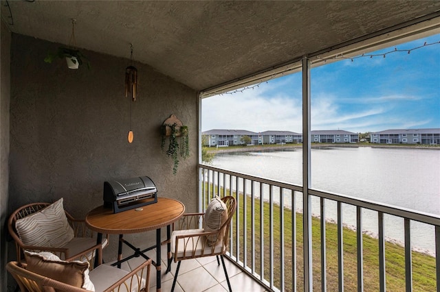 balcony featuring a water view and a residential view