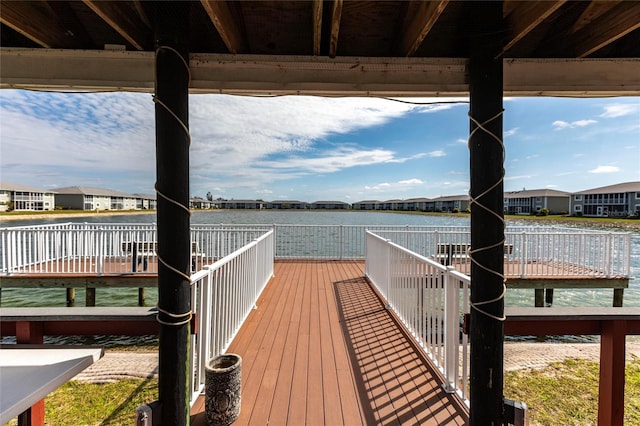 dock area featuring a water view and a residential view