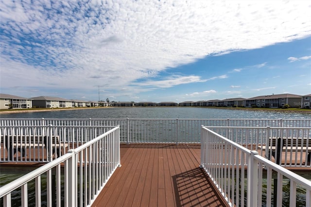 wooden deck featuring a residential view and a water view