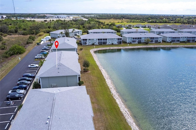 drone / aerial view with a water view and a residential view