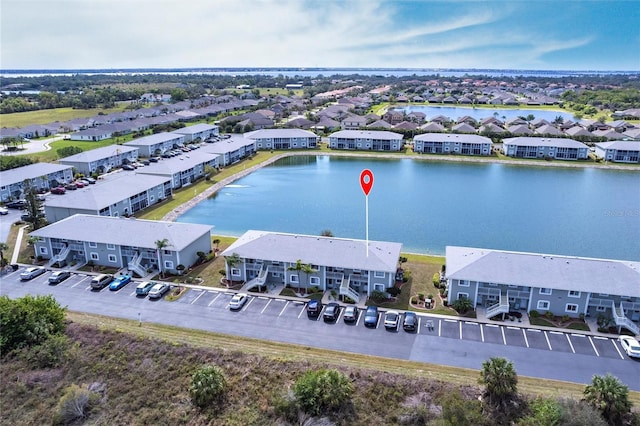 drone / aerial view featuring a residential view and a water view