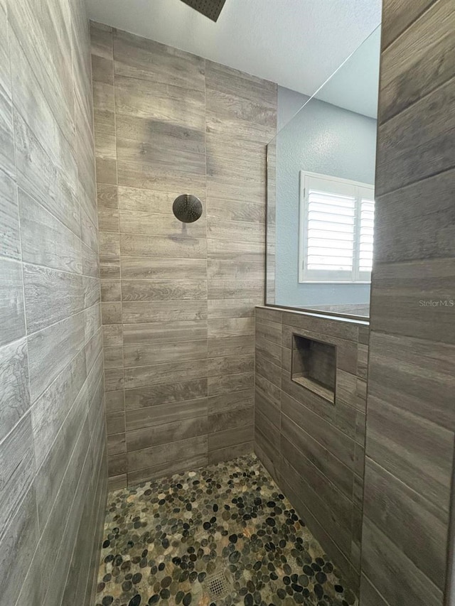 bathroom with tiled shower