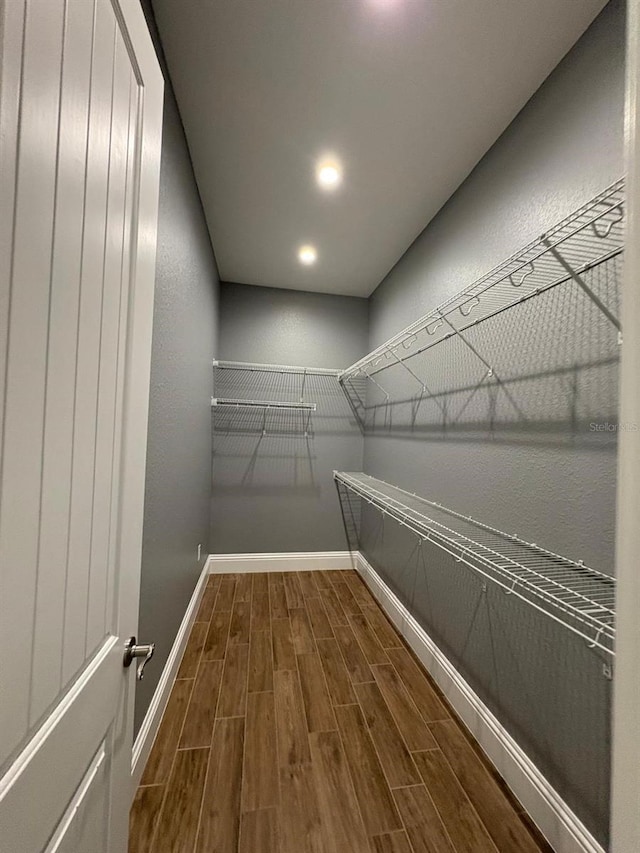 walk in closet with wood tiled floor