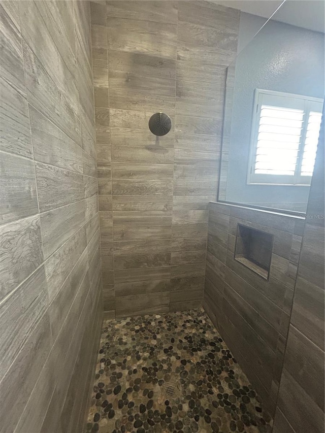 bathroom with tiled shower