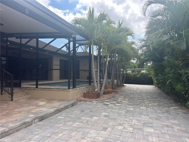 exterior space featuring a lanai and an outdoor pool